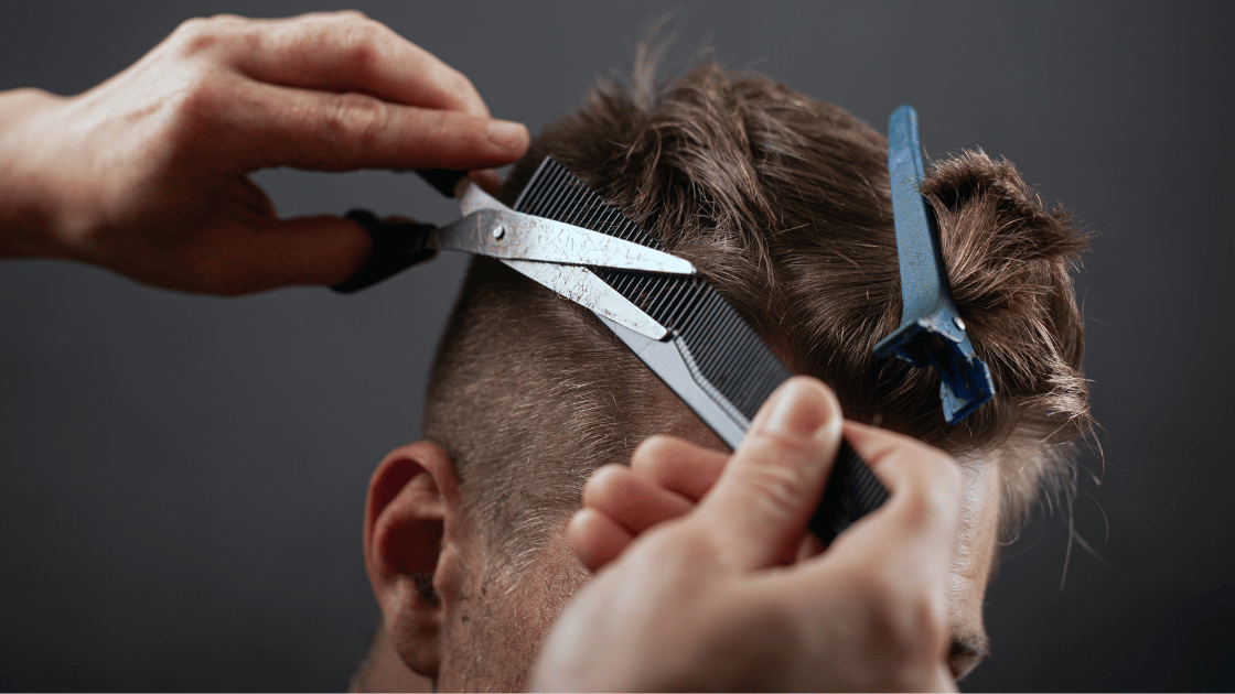 A man with an oval face shape getting a haircut